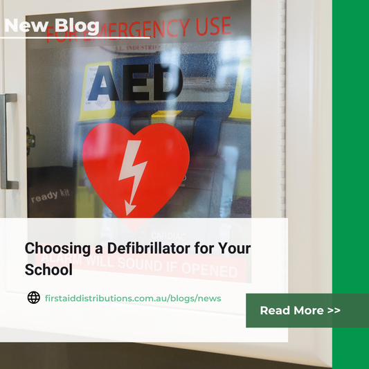 Wall-mounted AED cabinet in a school corridor near the front office