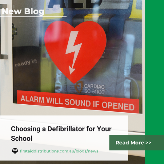 New blog: Choosing a Defibrillator for Your School, shown over an AED in a glass-fronted wall cabinet with a red heart symbol
