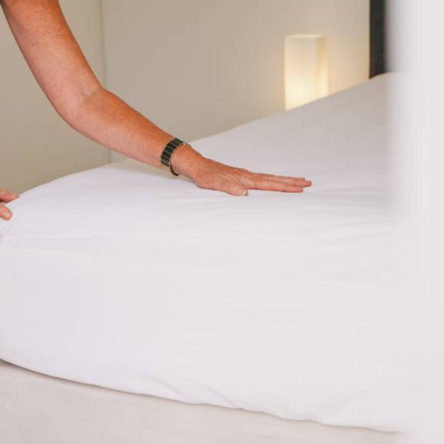Conni premium waterproof mattress protector with micro-plush technology for incontinence bedding, shown on a bed.