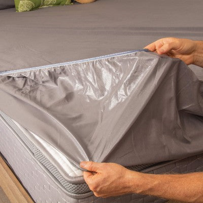 Conni premium waterproof mattress protector with micro-plush technology, designed for incontinence bedding, shown on a mattress.